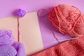 Knitting accessories skeins of yarn knitting needles and knitted blanks on a pink background needlework on a background of self-is