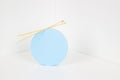 Knitting background. Round blue product display presentation podium with wooden knitting needles on white background