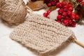 Knitting beige and red berries