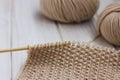 Knitting. Beige yarn on white background Royalty Free Stock Photo