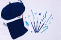 Knitting and crocheting flatlay.Blue yarn skein, crochet hook, row counter on white background isolated.Knit hat process