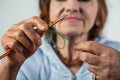 Knitting. Elegant elderly woman holding needle and wool in hand and do knitting during her leisure. Seniour lady on