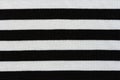 Knitting fabric with horizontal black and white stripes, texture. Striped  background Royalty Free Stock Photo
