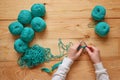 Knitting. Hand Crochet. Female hand knit hook. Top view. Knitting in woman hands. Close-up of hands knitting. Colorful threads.