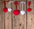 Knitting hearts on old wooden panel