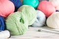 Knitting hobby composition with colorful yarn balls and needles on white wooden background. Close up Royalty Free Stock Photo