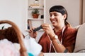 Knitting makes me happy. a young woman knitting while relaxing at home. Royalty Free Stock Photo