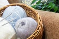 Knitting. Materials for a knitted project. Cozy handicraft atmosphere. Needlework. Balls of thread for knitting in a basket. Women