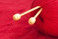 Knitting needle and red woolen yarn
