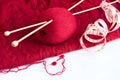 Knitting needle and red woolen yarn and other utencils Royalty Free Stock Photo