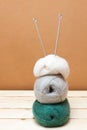 Knitting needles and balls of wool on a wooden table Royalty Free Stock Photo