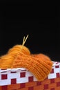 Knitting orange colorful melange mohair wool ball and knitting needles in the red box. The beginning of comfort knit cloth. Place Royalty Free Stock Photo