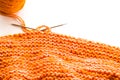 Knitting, orange wool on white Royalty Free Stock Photo