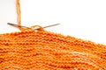 Knitting, orange wool on white Royalty Free Stock Photo