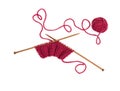 Knitting pattern on wooden needles of woolen threads red color Royalty Free Stock Photo