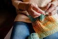 Knitting a scarf with colorful melange threads