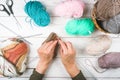 Knitting in woman hands. Close-up of hands knitting. Colorful threads. Selection of colorful yarn wool. Knitting