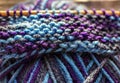 Knitting on wooden knitting needles from violet blue purple yarn close-up. Hobby, homemade Royalty Free Stock Photo