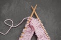 Knitting Wool and Pink Knitting Needle with Heart Shape from wire. Dark Gray Background. Hobby and Handmade.
