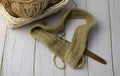 Knitting work with wood crochet hook put beside cotton thread Royalty Free Stock Photo