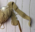Knitting work with wood crochet hook put beside cotton thread Royalty Free Stock Photo