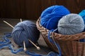 Knitting yarn, knitting needles and wicker basket Royalty Free Stock Photo