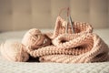 Knitting yarn, needles, chunky sweater. Cozy homely atmosphere. Yarn in warm colors of peach, beige. Knitting as a hobby. Royalty Free Stock Photo