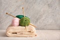 Knitting yarn with needles and scarf on wooden table Royalty Free Stock Photo