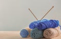 Knitting yarn with needles on table against light background Royalty Free Stock Photo