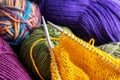 Knitting yarn, needles and unfinished clothes, closeup Royalty Free Stock Photo