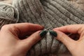 Knitting - young womans hands using knitting needles and grey wool roll. woman hands knitting Royalty Free Stock Photo
