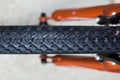 Knobby tread mountain bike tire up close on orange bike