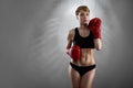 Knock out girl. Portrait of an attractive young female fighter wearing boxing gloves posing Royalty Free Stock Photo