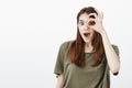 Knock knock who is there. Portrait of shocked good-looking female student in trendy t-shirt, holding okay or ok sign