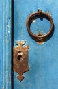 Knocker and lock on old blue wooden door Royalty Free Stock Photo