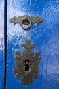 knocker and lock on old blue wooden door, on colonial city of Tiradentes, Minas Gerais state, Brazil Royalty Free Stock Photo