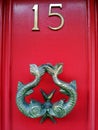 Knocker on red door number 15 with Pisces fish