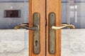Knockers and handles on ancient doors, Old metal door handle on a wooden door