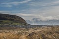 Knocknarea hill and Strandhill town in county Sligo, Warm sunny day, Nobody, Blue cloudy sky, Tall grass field in foreground