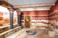 Knossos Palace in Crete, the interior of the throne room with a stone throne, columns and a bowl for ablutions.