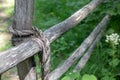 Knot bound wooden stick fence. rope tied of old fence. close up Royalty Free Stock Photo