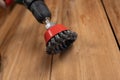 Knot cup wire brush installed in the cam of the power drill chuck. Tool for woodworking, sanding, removing rust from various