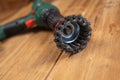 Knot cup wire brush installed in the cam of the power drill chuck. Tool for woodworking, sanding, removing rust from various