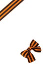 Knot in front of black orange ribbon on white background