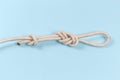 Knot ÃÂ°igure-eight loop with stopper knot on blue background