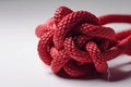 Knot of red nylon rope closeup isolated on white background. Generative AI Royalty Free Stock Photo