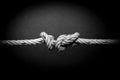 A knot tied on a rope, dissolved problem, unsolved problem, on white background. Problem knot. Can\'t fix it. Macro shot