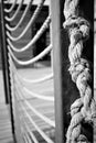 Knots on the rope. Ropes attached to iron beams. Black and white.