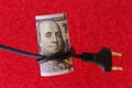 Knotted electric cord around the neck of the president of the dollar bill, selective focus. Concept of the energy crisis