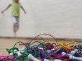 A knotted pile of skipping jump ropes on the floor